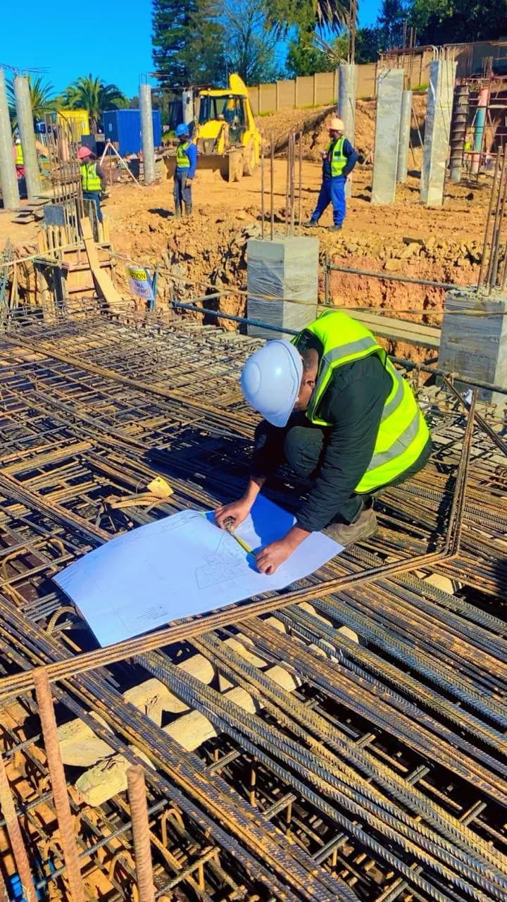 KAM Electrical electrician setting out from drawings on slab reinforcement